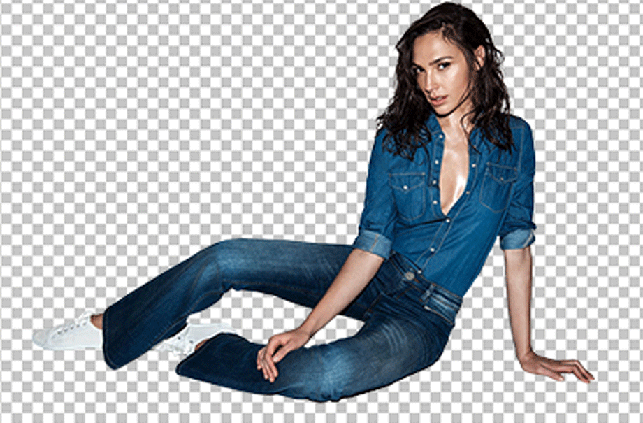 Gal Gadot wearing a jean jacket and jeans pants and giving a pose while sitting on the floor png image.
