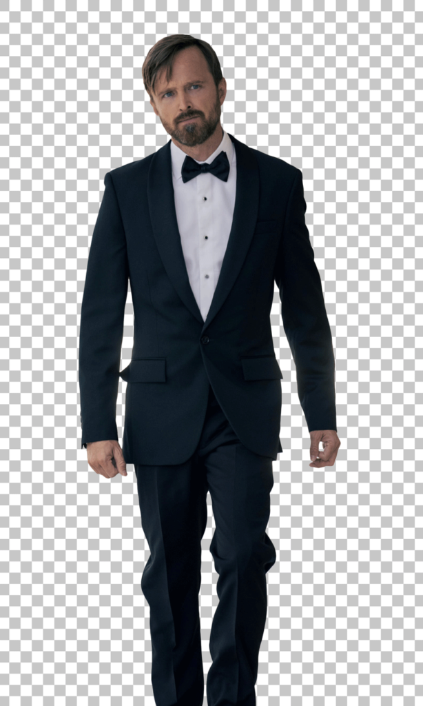 Aaron Paul walking and earing a black tuxedo with a white shirt and black bow tie png image