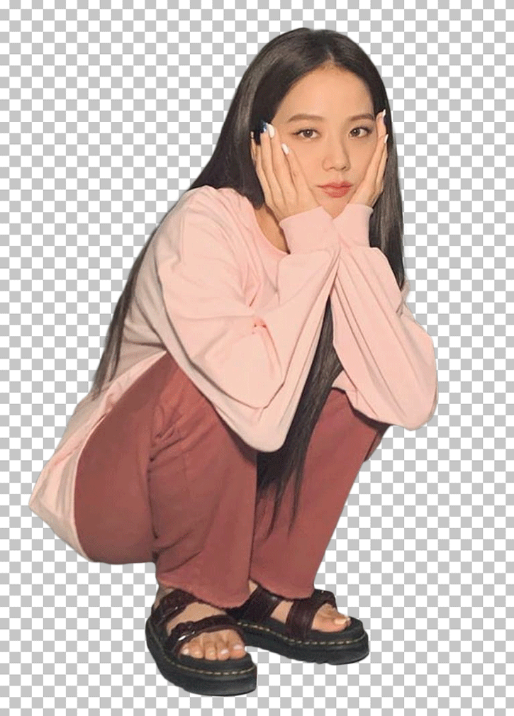 Jisoo sitting in pink shirt and brown pants kneeling on the ground