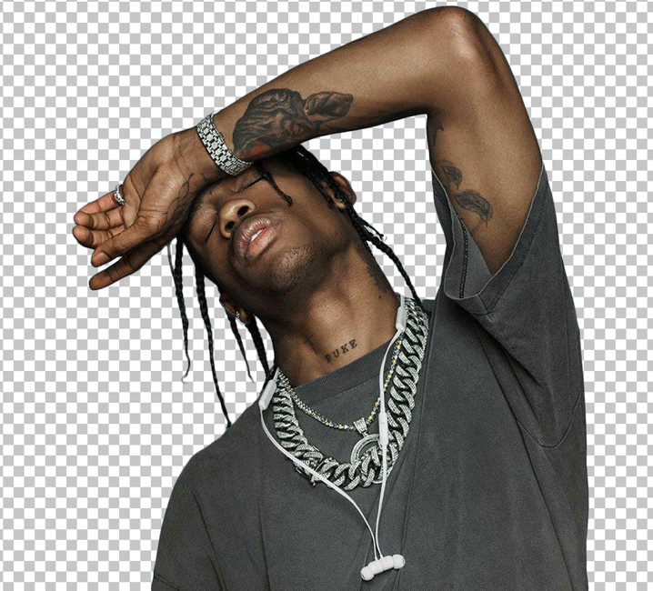 Travis Scott, a tattooed artist, wearing a black t-shirt, shielding his eyes from the sun with raised hands
