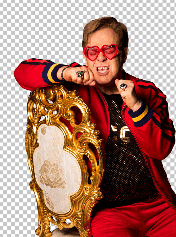 Elton John happy and sitting in the chair