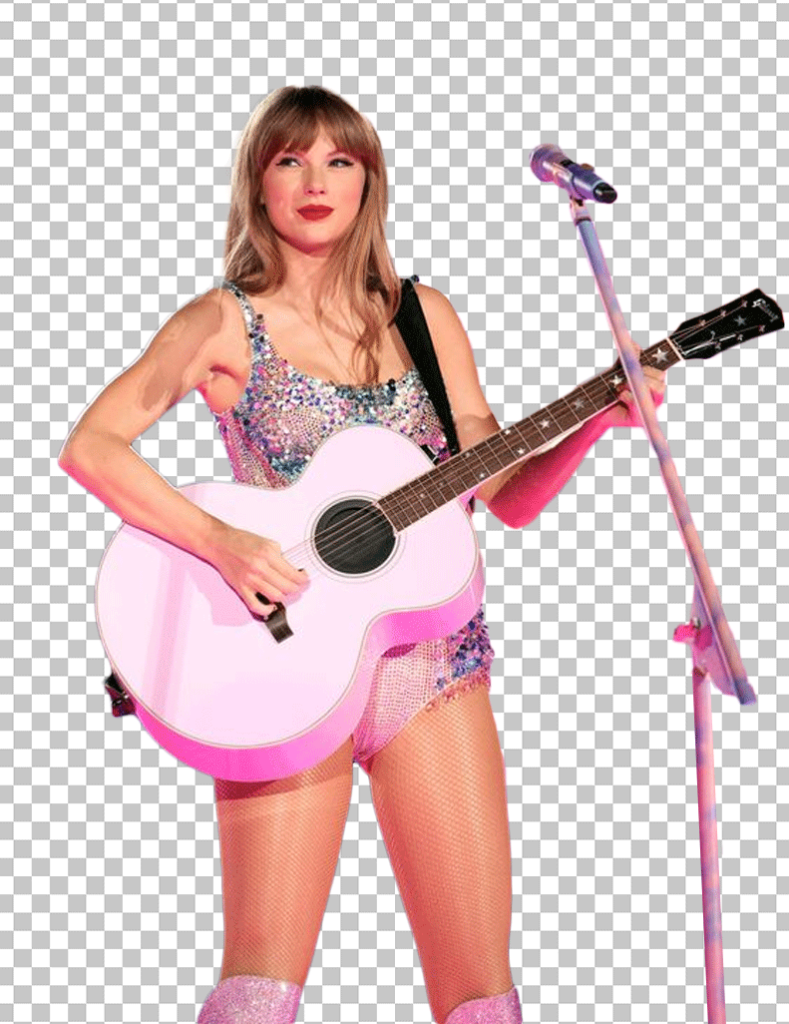 Taylor Swift is playing the pink guitar and standing in front of a microphone.