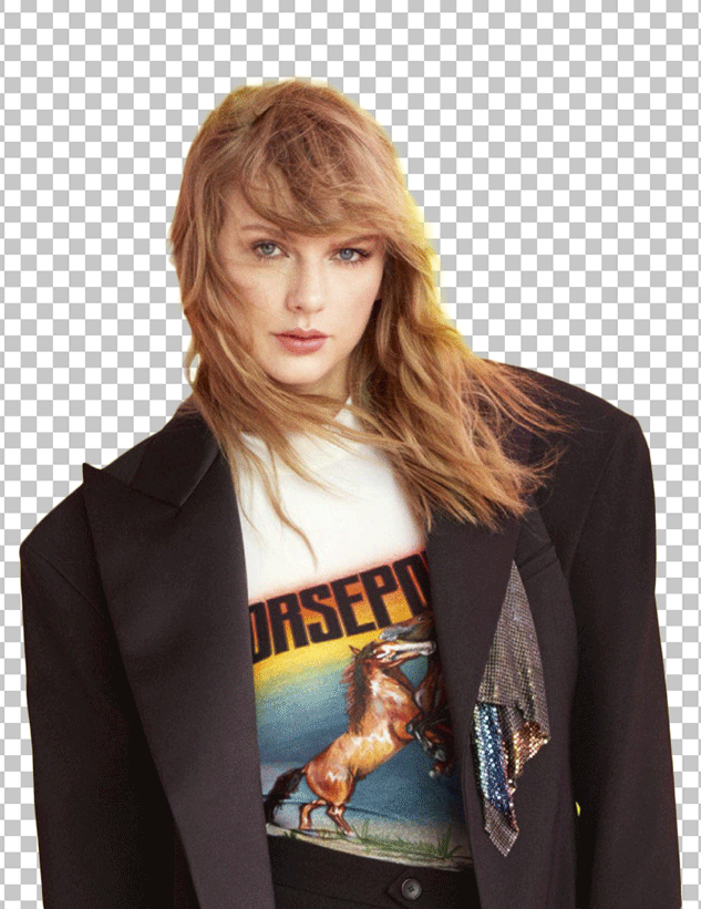 Taylor Swift Standing in oversize blazer and white t-shirt.