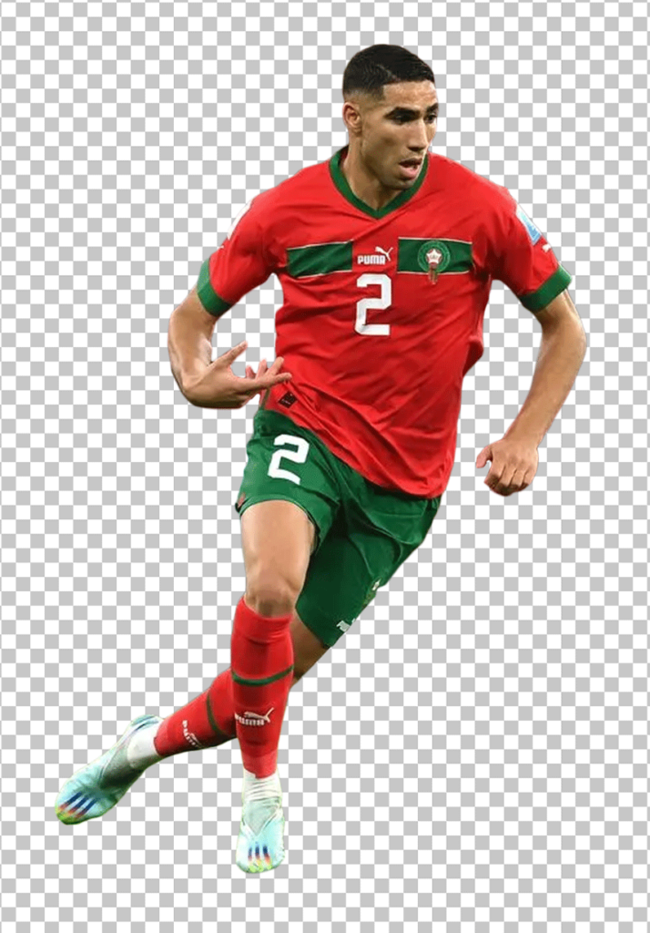 Achraf Hakimi is running and wearing Moroccan jersey.