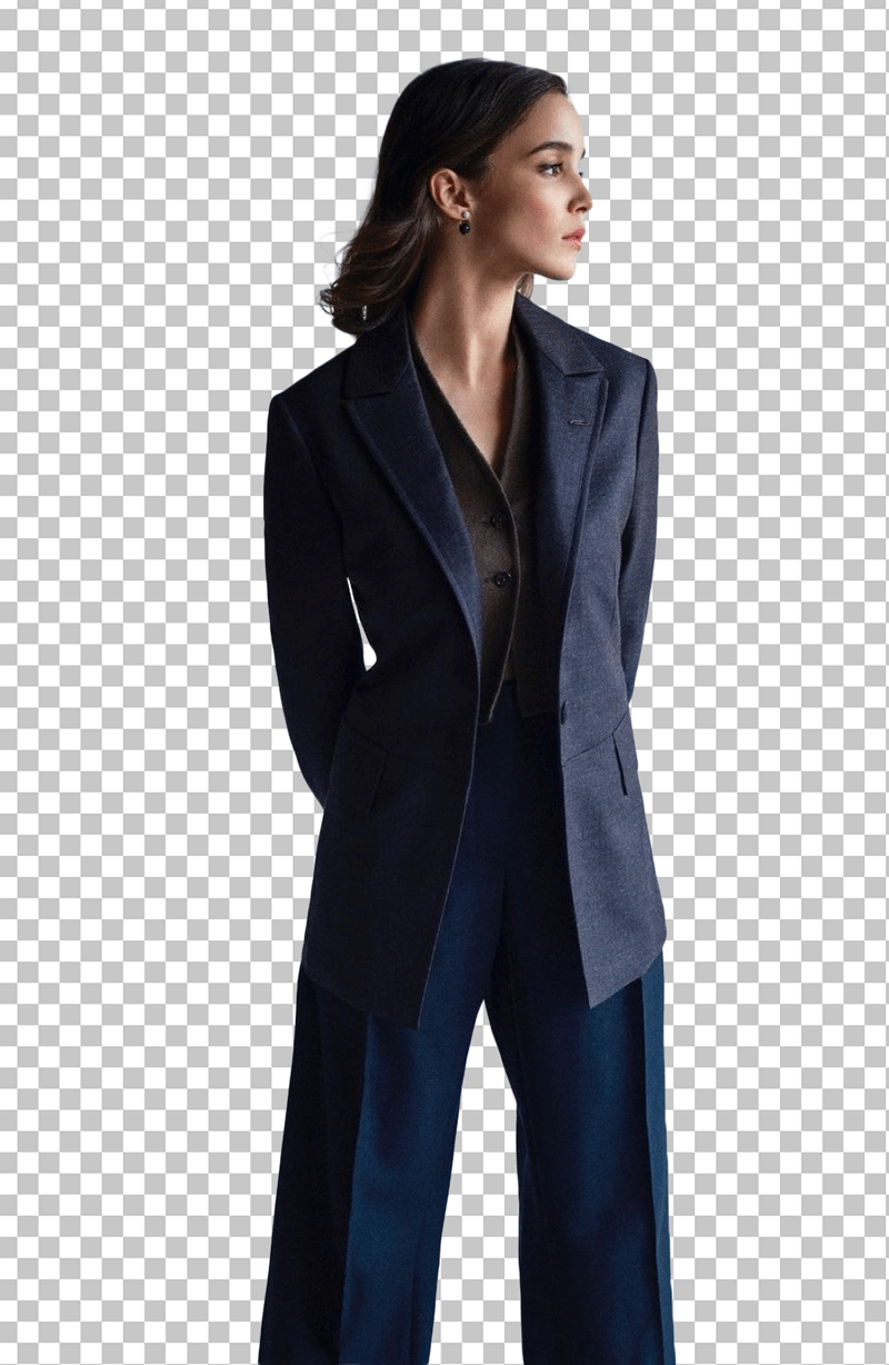 Alba Baptista Standing in navy blue blazer and wide-leg pants.