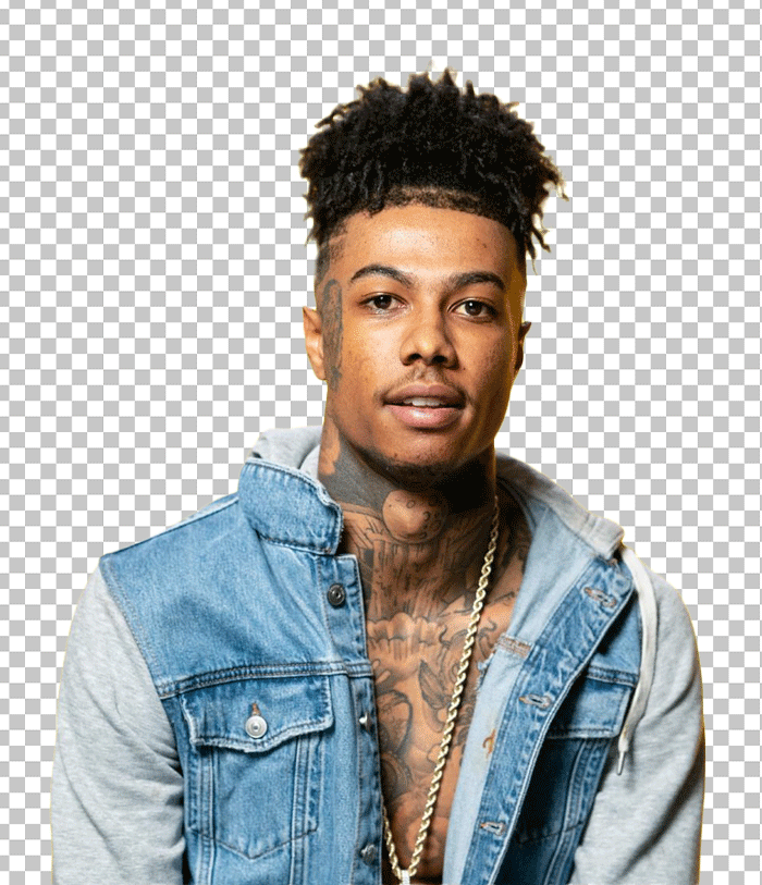 Blueface with tattoos on his arms and chest, wearing a denim jacket and a white t-shirt.