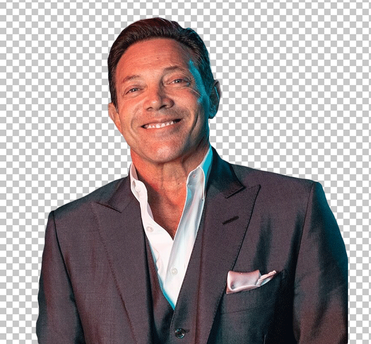 Jordan Belfort in a suit and white shirt, smiling PNG Image.