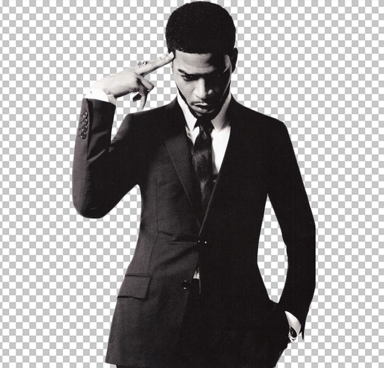 Black and white image of Kid Cudi is in a black suit with his hands on his head and thinking PNG Image