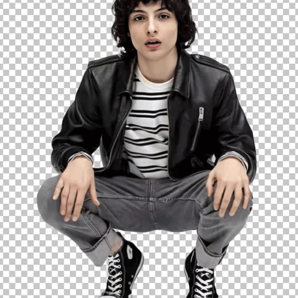 Finn Wolfhard is sitting on his knees and wearing a black leather jacket.