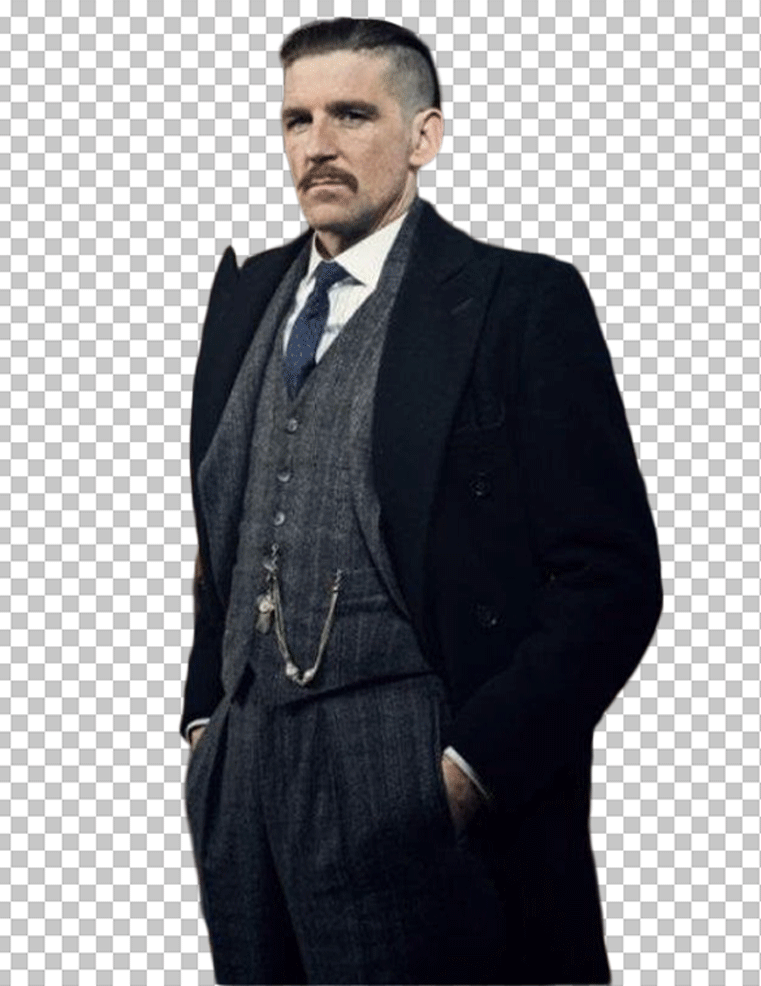 Arthur Shelby is standing in a black suit and tie with a white shirt.