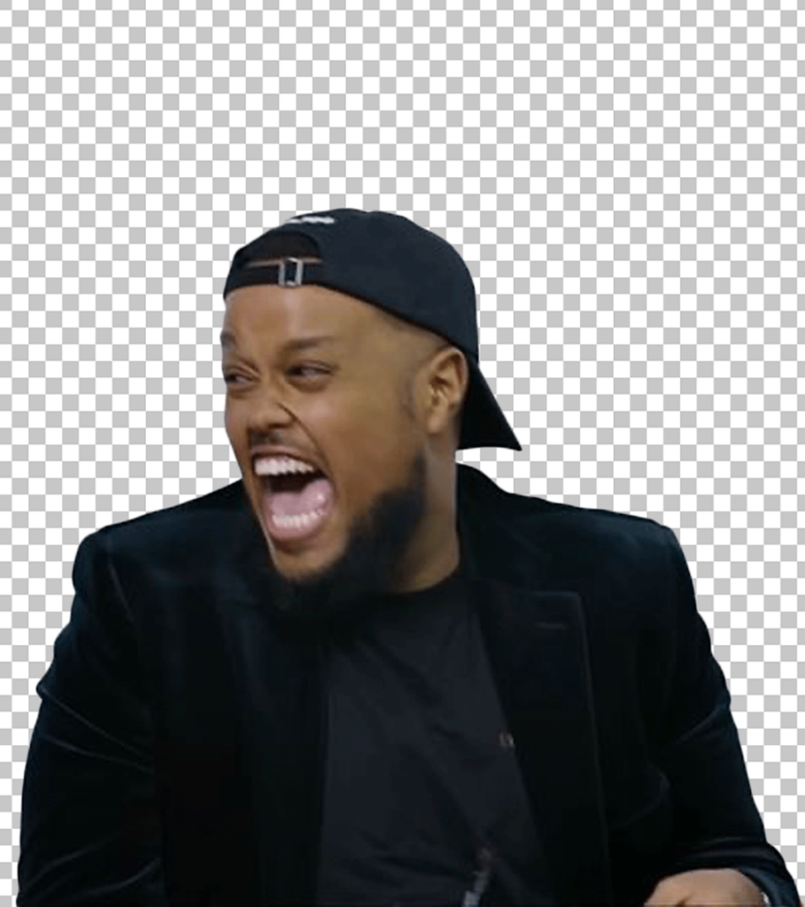 Chunkz is wearing a black jacket and a black cap and laughing.