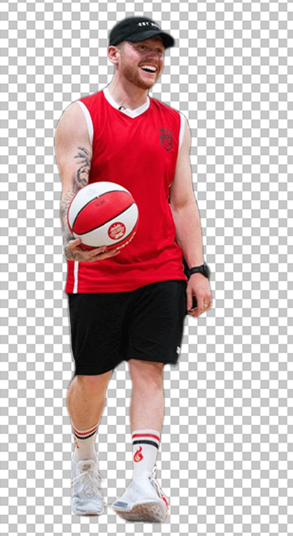Ethan Payne is wearing a red jersey and black shorts and holding a basketball.