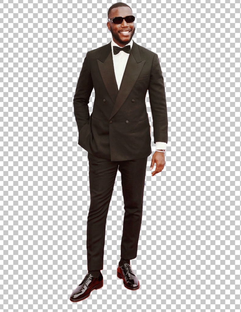 Harry Pinero is standing in a suit PNG Image
