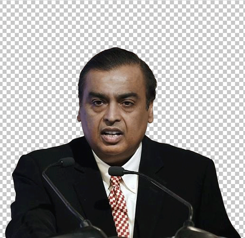 Mukesh Ambani, in a suit and tie, standing at a podium, speaking into a microphone.