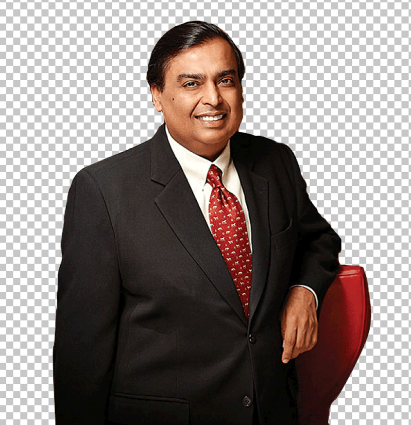 Mukesh Ambani in a business suit and tie, standing in front of a red chair PNG Image