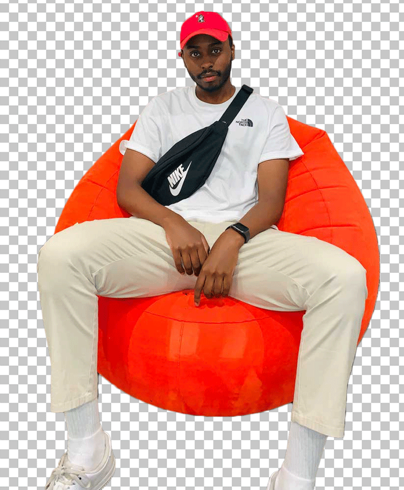 Sharky is sitting on an orange bean bag PNG Image