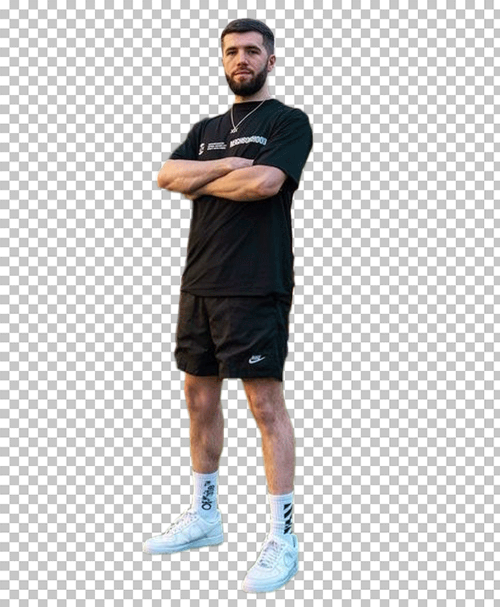 Josh Zerker is standing in a black t-shirt, pants, and white sneakers PNG Image