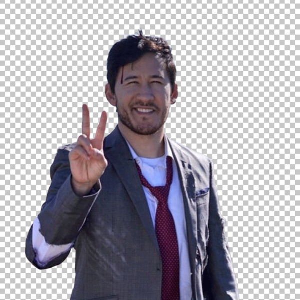 Markiplier in a suit and tie, with his hands raised in a peace sign.